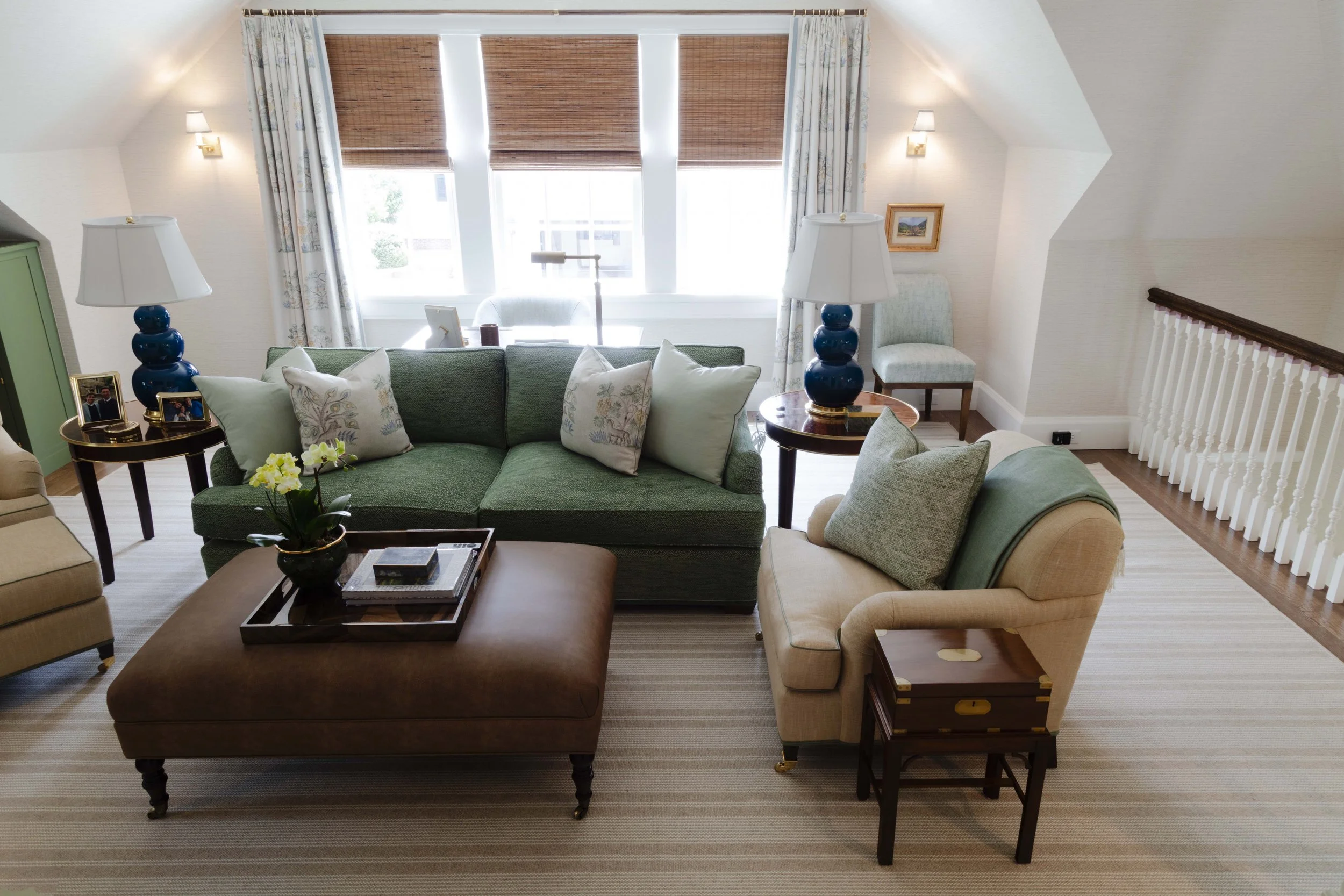 Living room with green sofa and floral curtains
